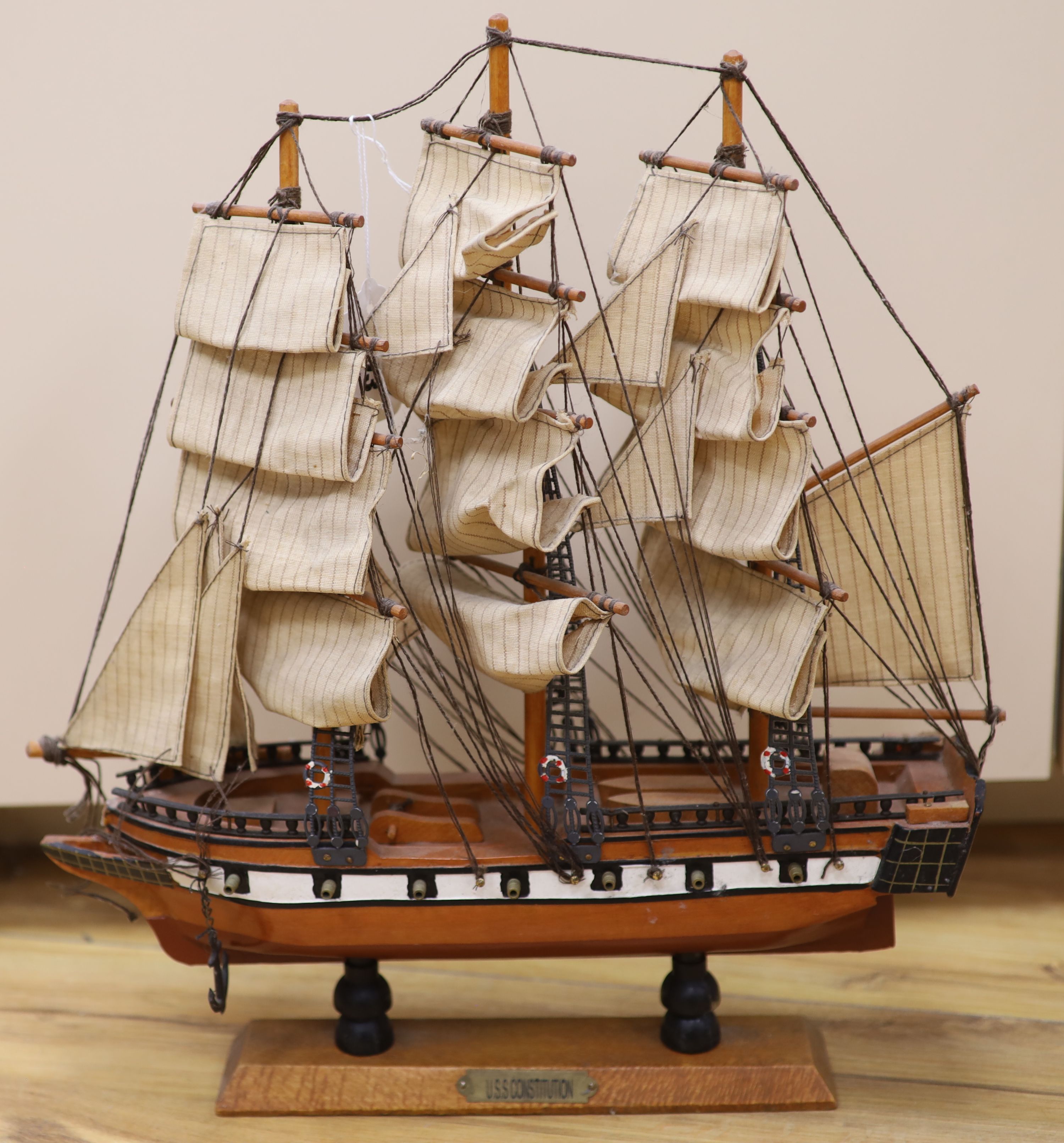 Three model ships: The Cutty Sark, The USS Constitution and Fragata, together with a carved wood Marlin